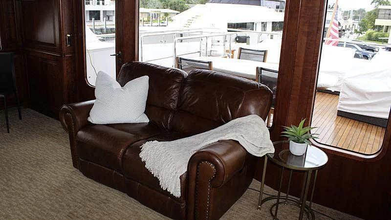 a couch in a living room aboard DRIVEN Yacht for Sale