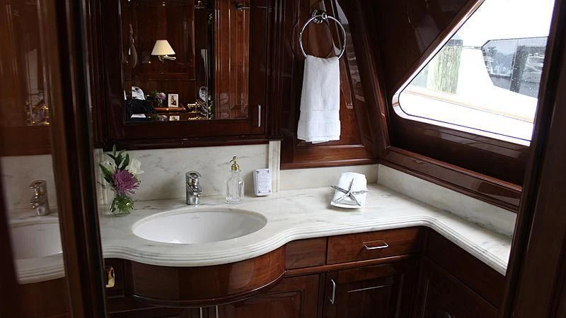 a bathroom with a sink and a mirror aboard DRIVEN Yacht for Sale