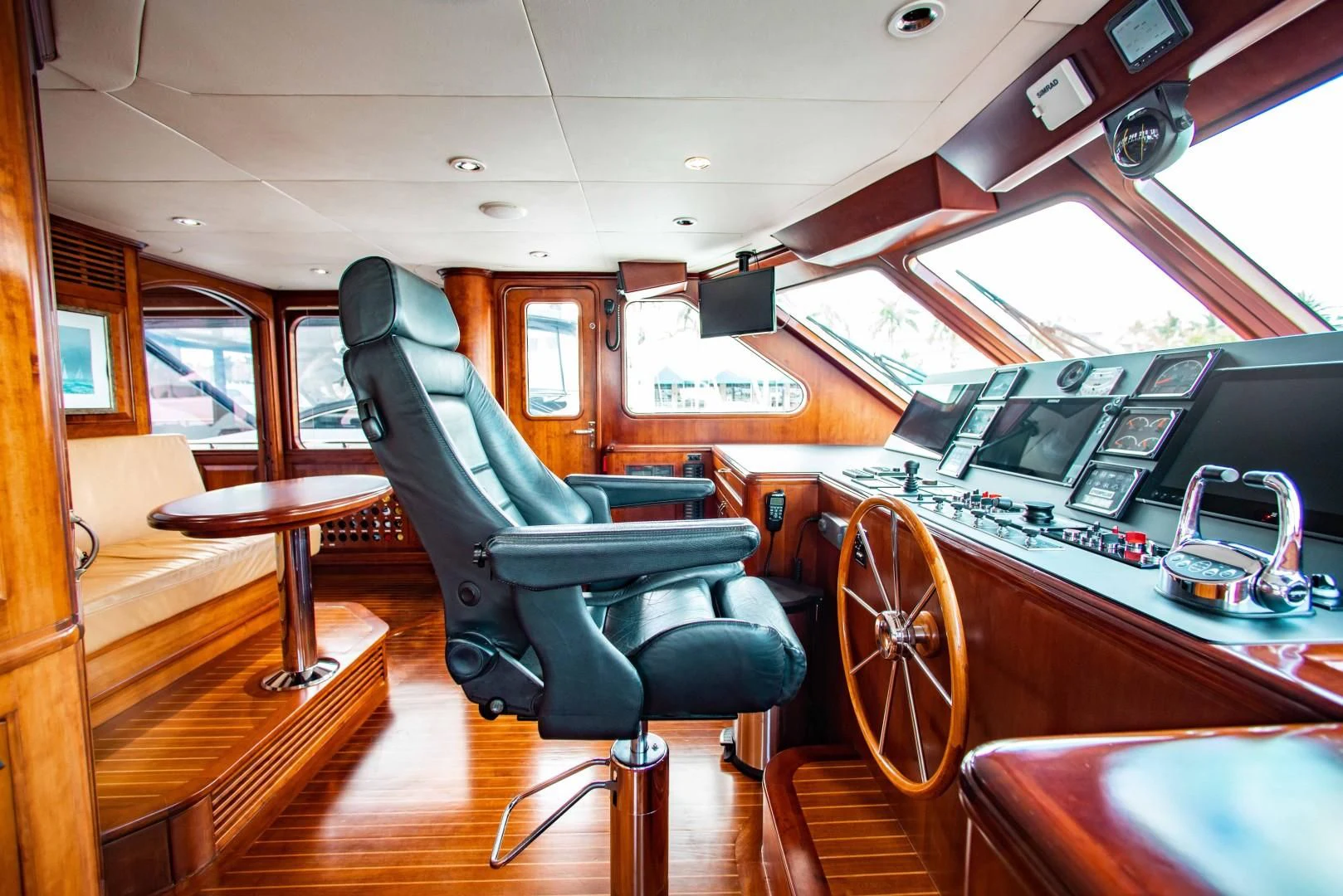 a room with a car and a table and chairs aboard DRIVEN Yacht for Sale