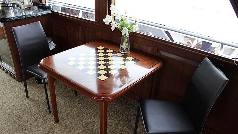 a table with a vase of flowers on it aboard DRIVEN Yacht for Sale