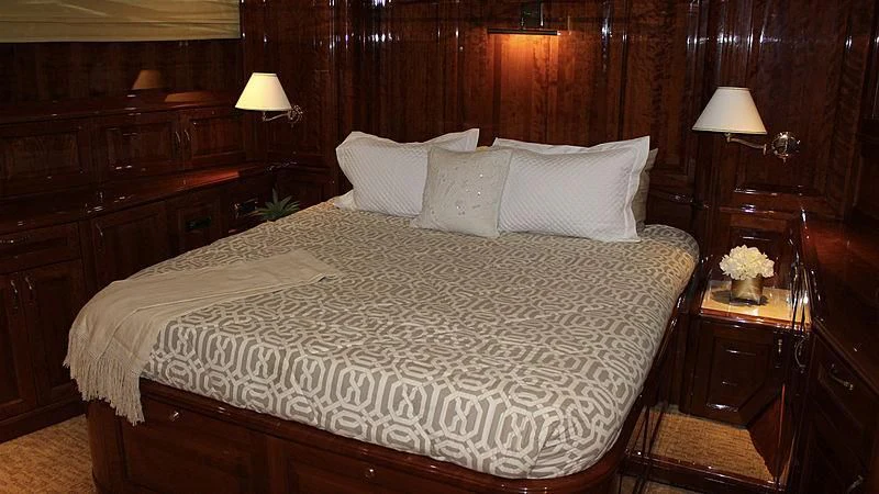 a bed with white sheets aboard DRIVEN Yacht for Sale