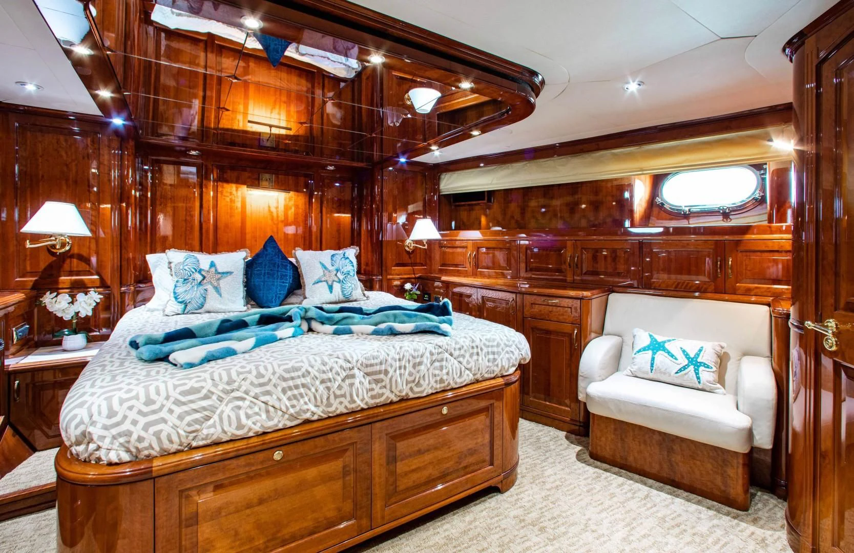 a bedroom with a bed and a chair aboard DRIVEN Yacht for Sale