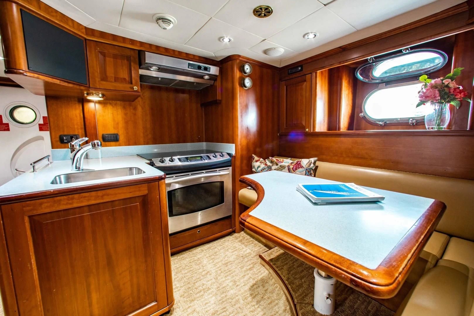 a kitchen with a table and a bed aboard DRIVEN Yacht for Sale
