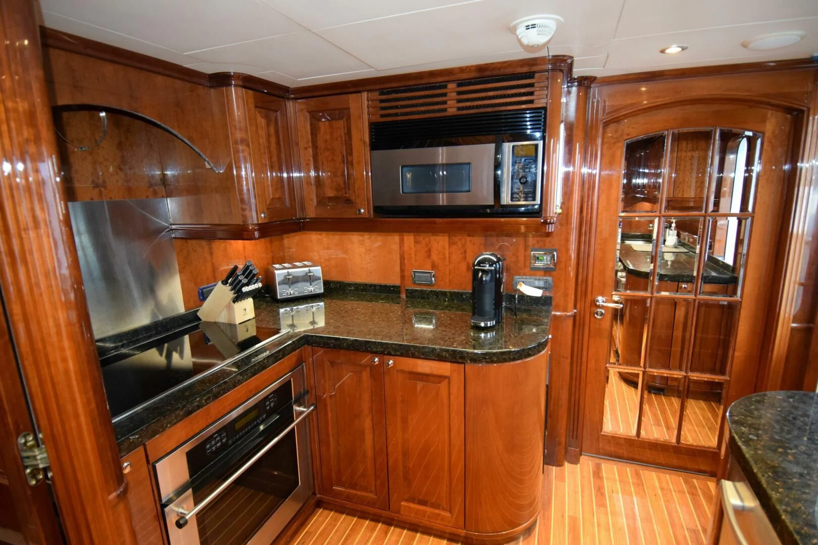 a kitchen with wooden cabinets aboard DRIVEN Yacht for Sale