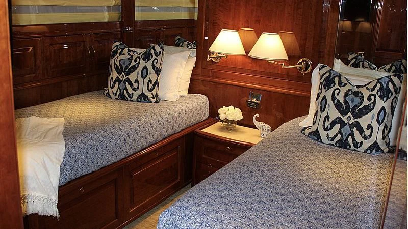 a bed with a white comforter and pillows aboard DRIVEN Yacht for Sale