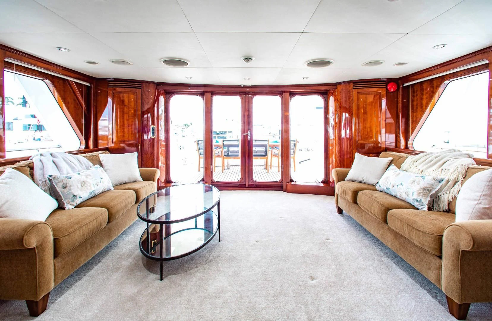 a living room with a table and couches aboard DRIVEN Yacht for Sale