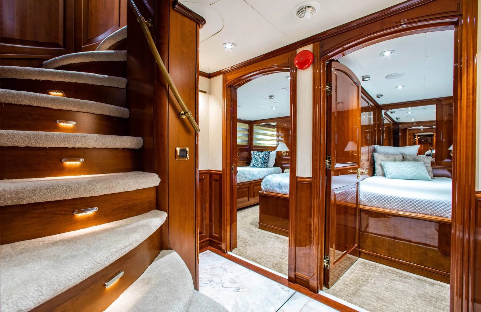 a room with a bed and a mirror aboard DRIVEN Yacht for Sale