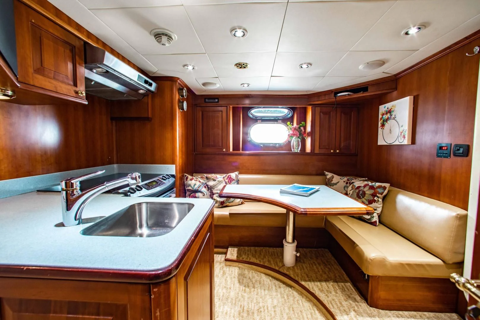 a living room with a kitchen and a bar aboard DRIVEN Yacht for Sale