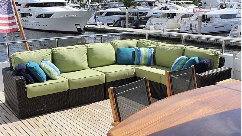 a couch and chairs on a deck aboard DRIVEN Yacht for Sale