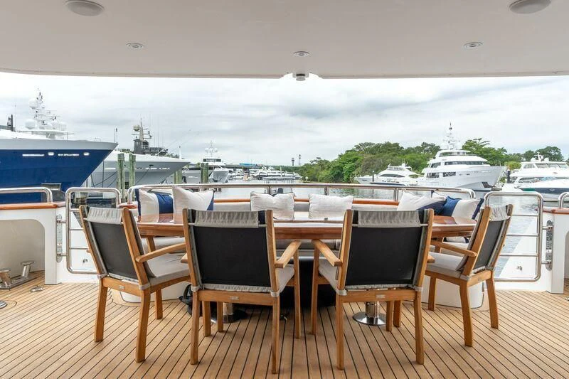 a deck with chairs and tables on it aboard DRIVEN Yacht for Sale