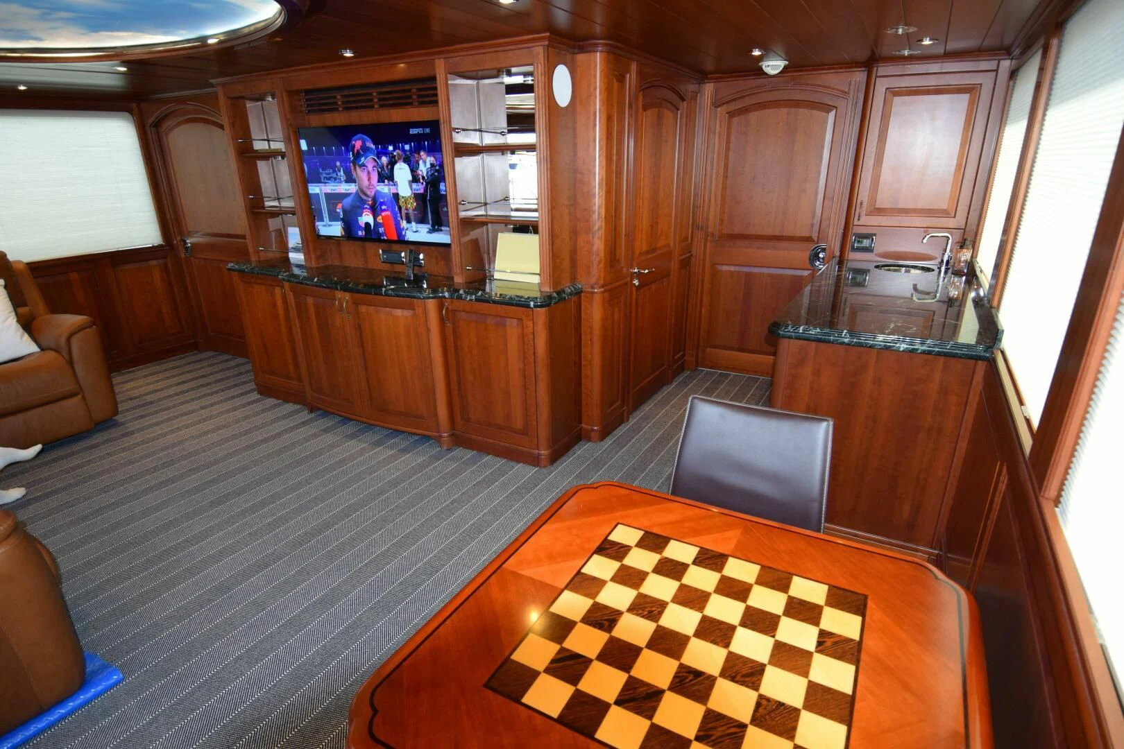 a large kitchen with wood cabinets aboard DRIVEN Yacht for Sale