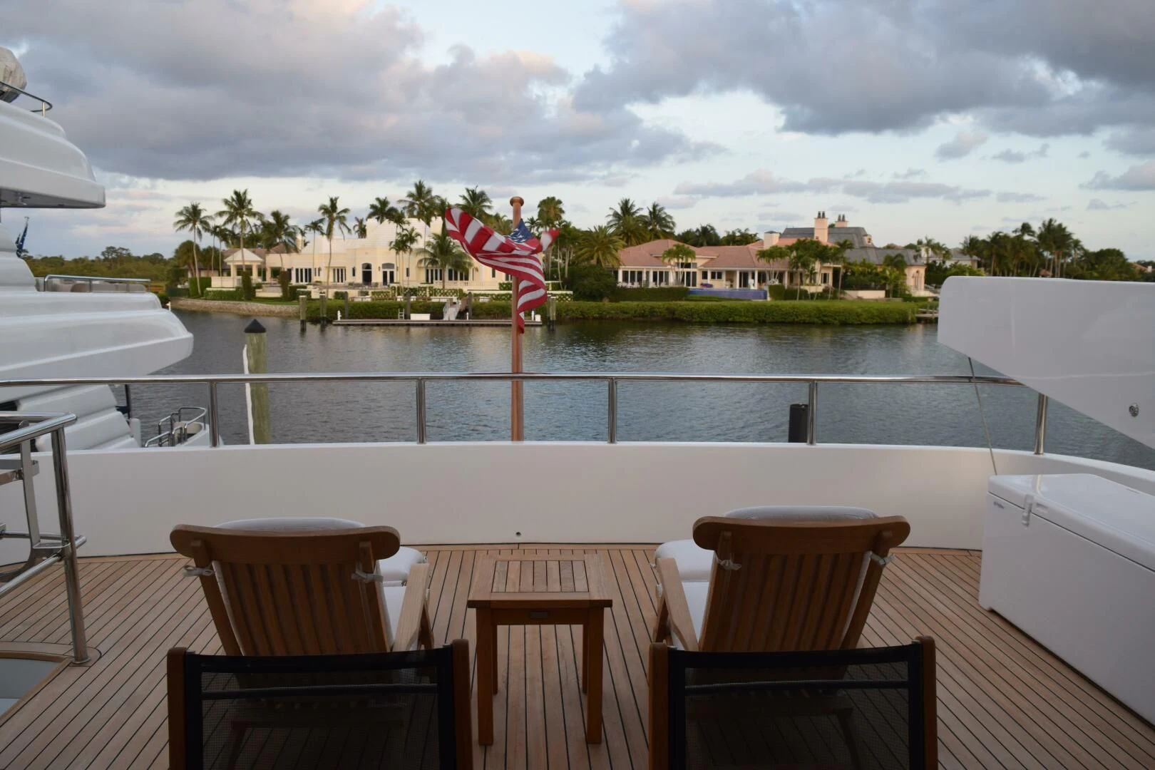 a group of chairs on a deck overlooking a body of water aboard DRIVEN Yacht for Sale
