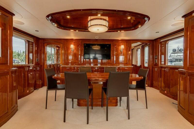 a room with a table and chairs aboard DRIVEN Yacht for Sale