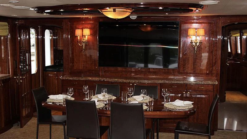 a dining room with a table and chairs aboard DRIVEN Yacht for Sale