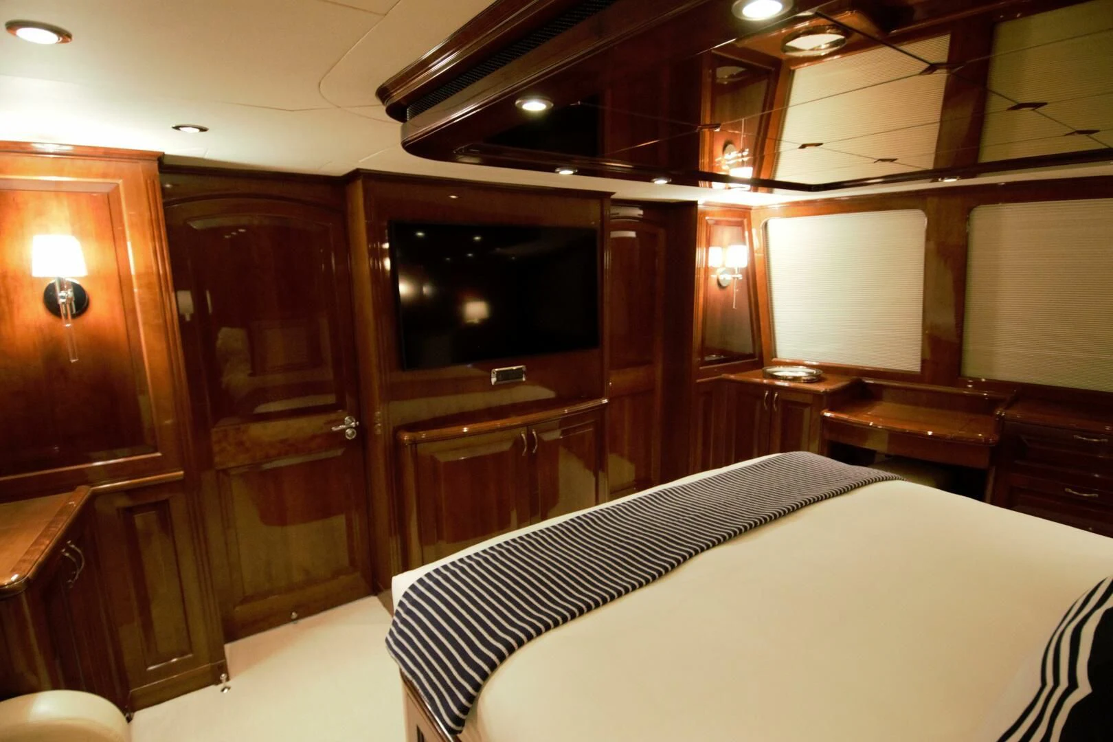 a room with a bed and a television aboard DRIVEN Yacht for Sale