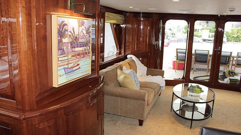 a living room with a couch and a coffee table aboard DRIVEN Yacht for Sale