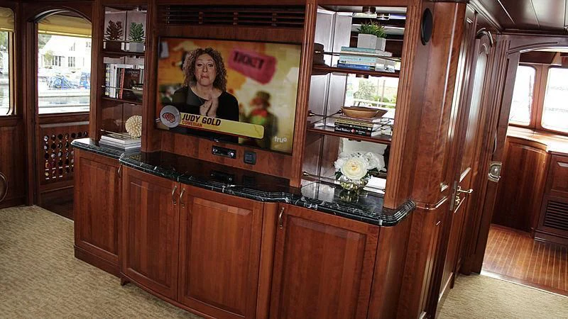 a wood cabinet with a painting on it aboard DRIVEN Yacht for Sale