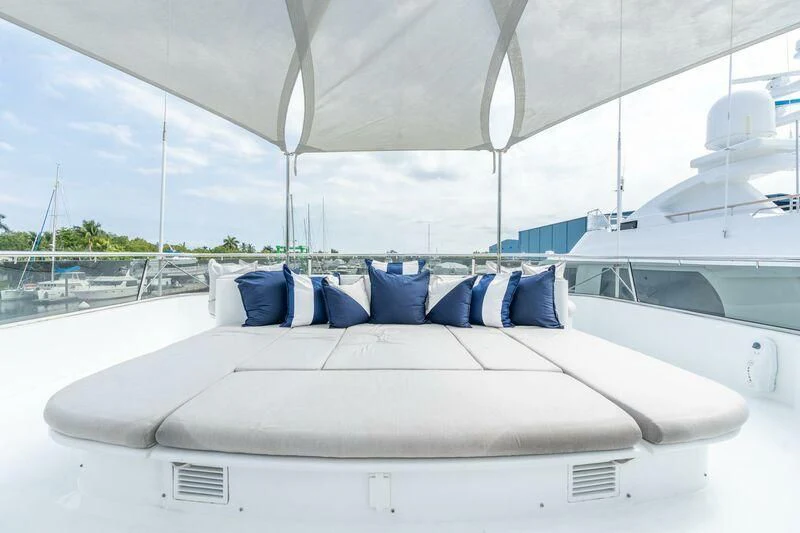 a white yacht with blue pillows aboard DRIVEN Yacht for Sale