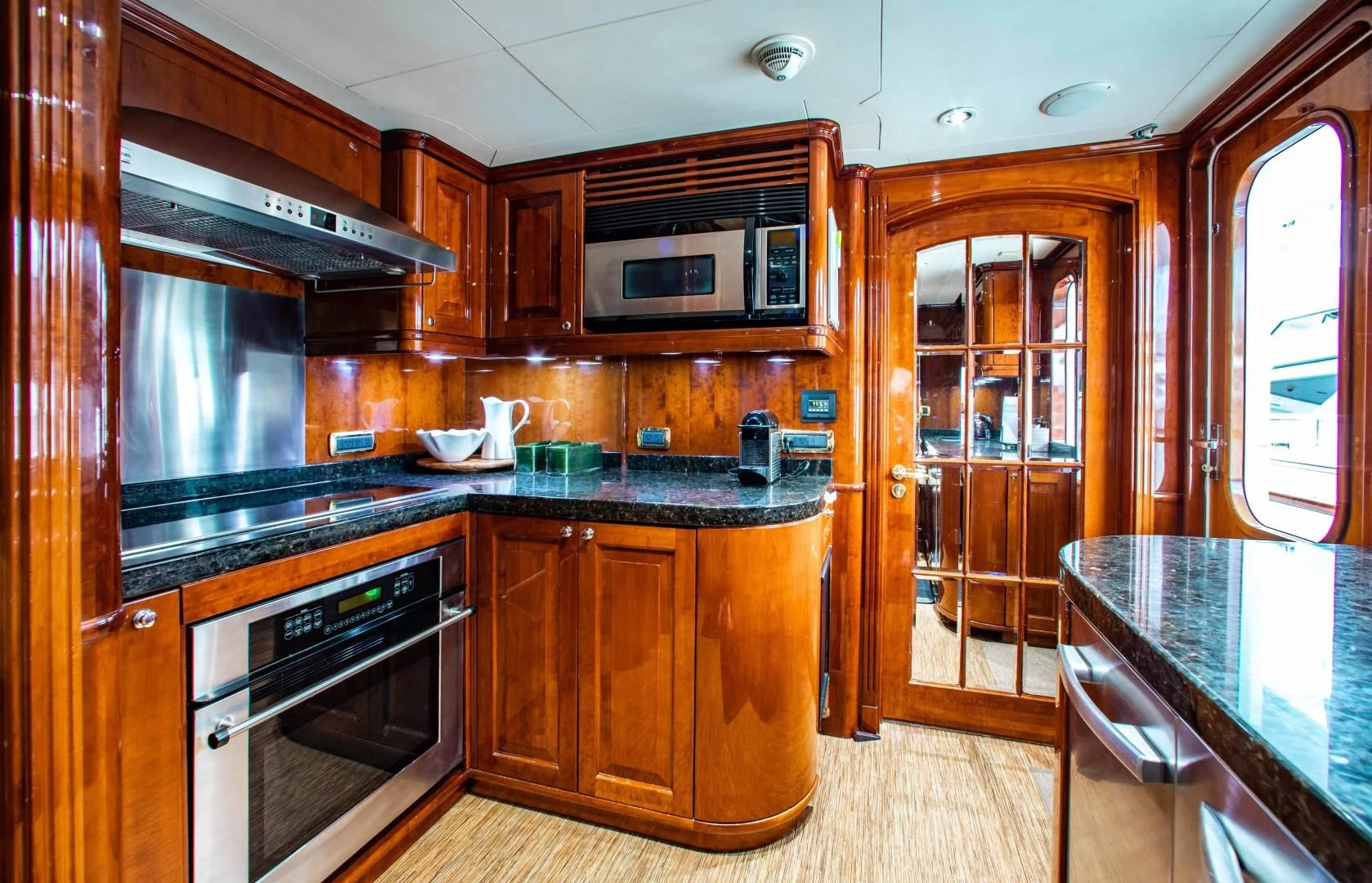 a kitchen with wooden cabinets aboard DRIVEN Yacht for Sale