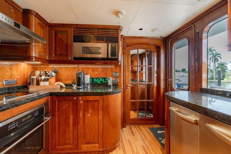 a kitchen with wooden cabinets aboard DRIVEN Yacht for Sale