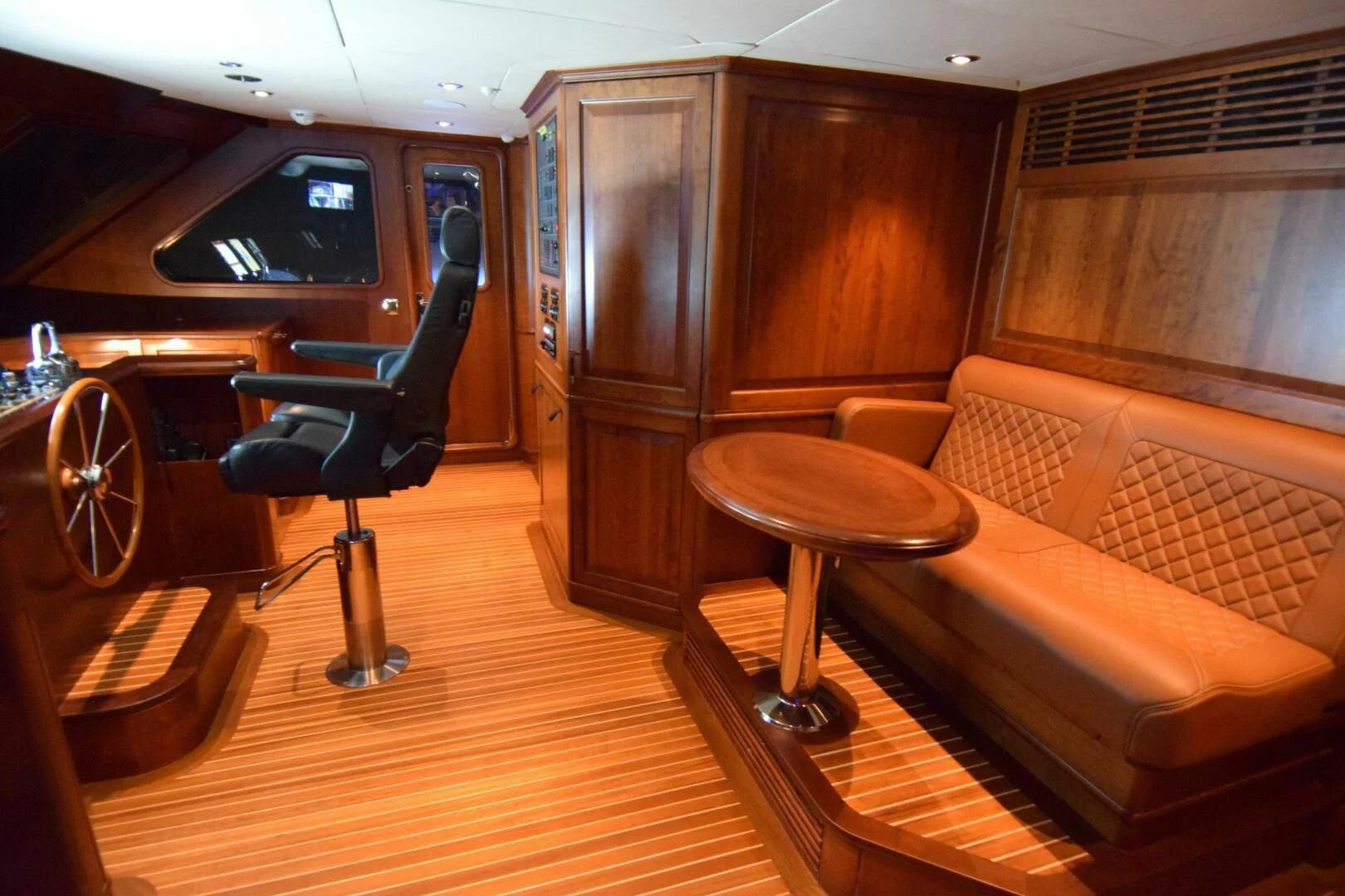 a room with a couch and a table and chairs aboard DRIVEN Yacht for Sale