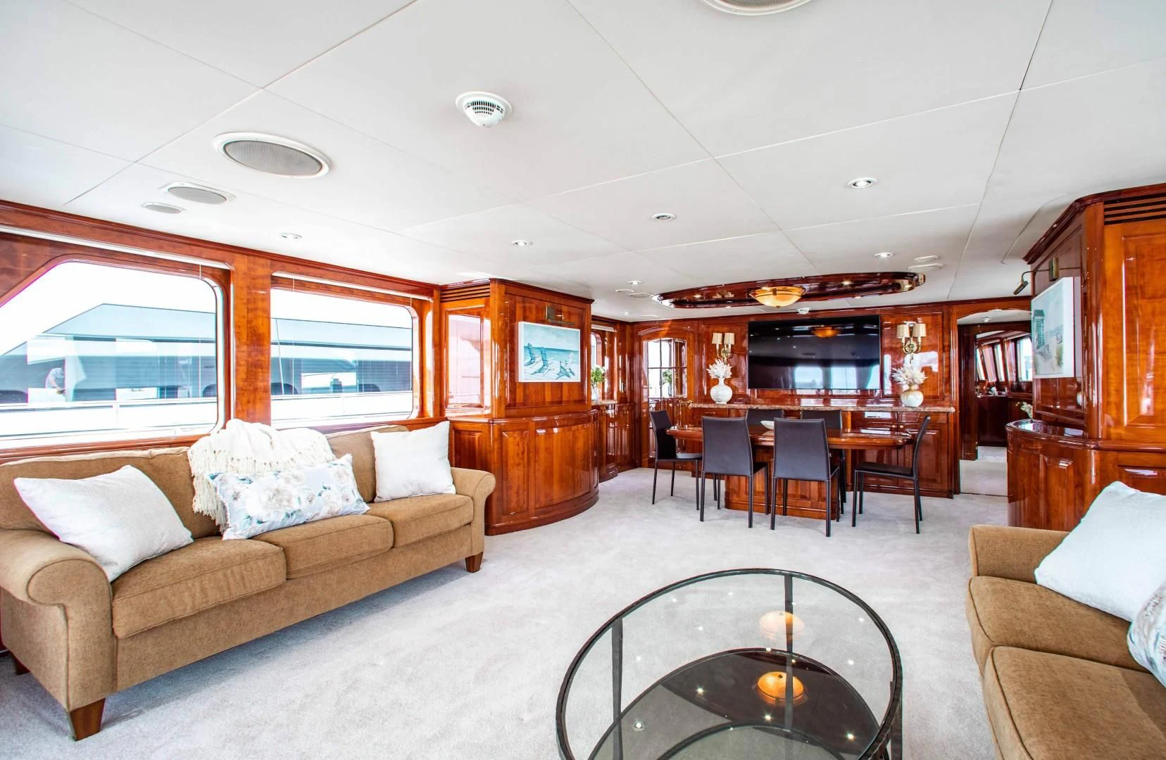 a living room with a couch and a table aboard DRIVEN Yacht for Sale