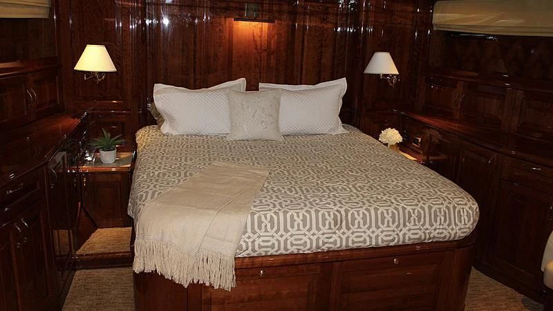 a bed with white sheets aboard DRIVEN Yacht for Sale