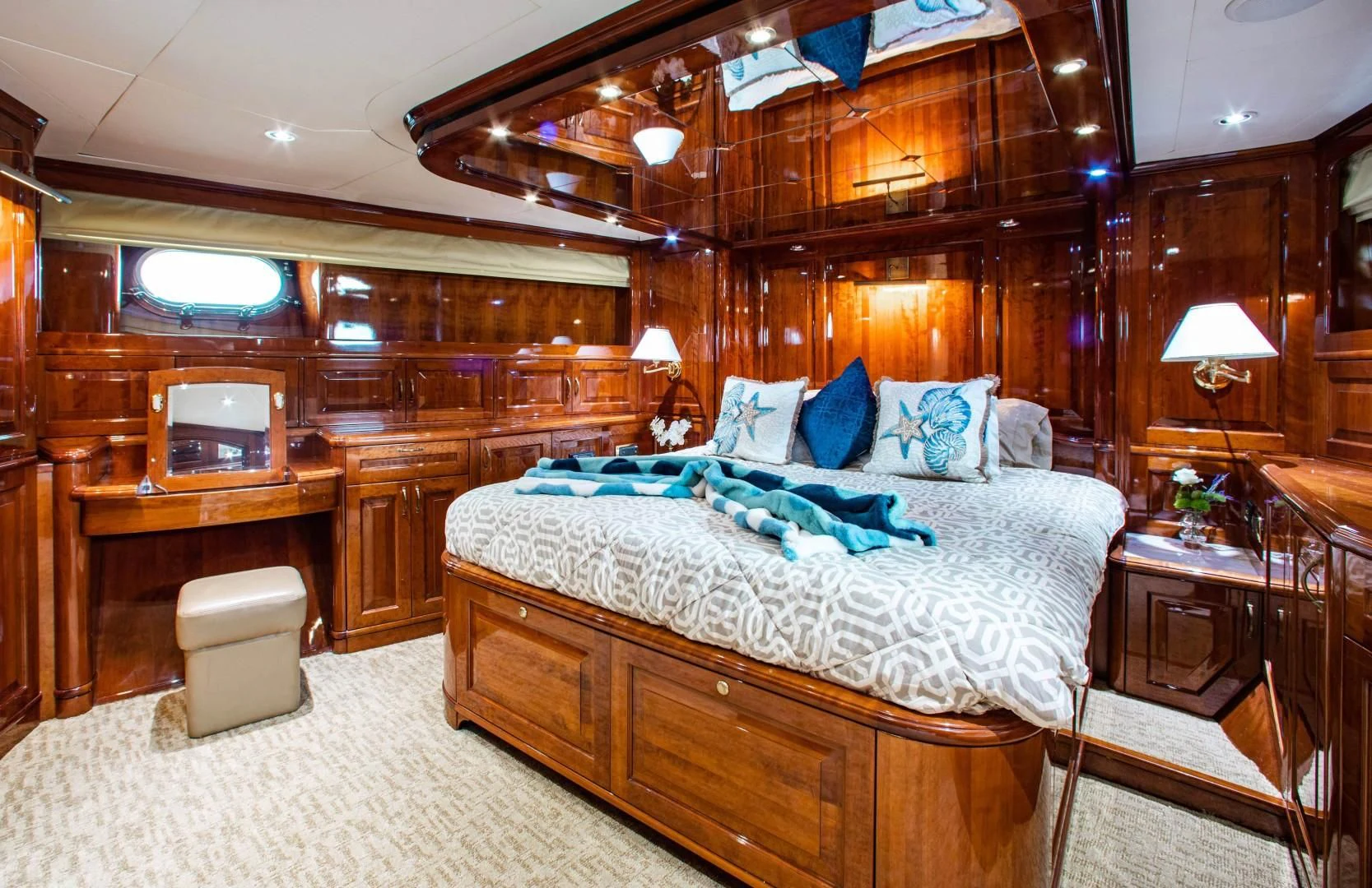 a bedroom with a bed and a desk aboard DRIVEN Yacht for Sale
