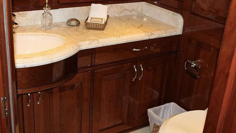a bathroom with a sink and a basket on the counter aboard DRIVEN Yacht for Sale