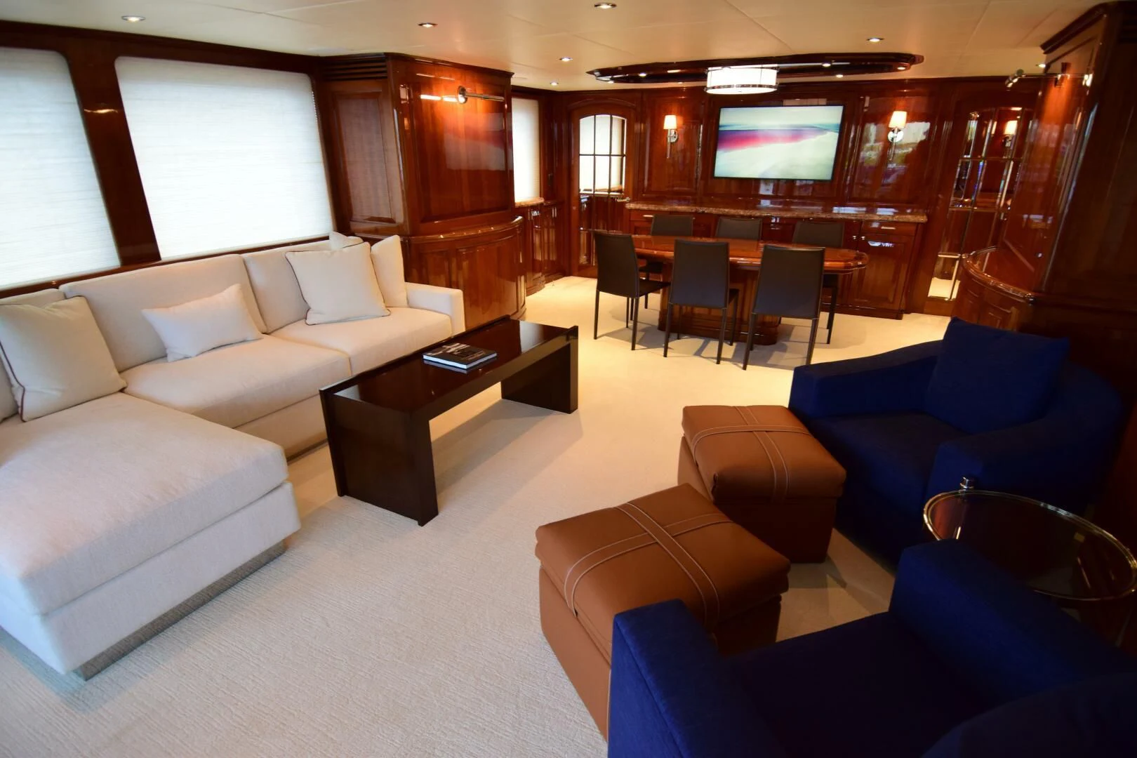 a room with couches and a television aboard DRIVEN Yacht for Sale