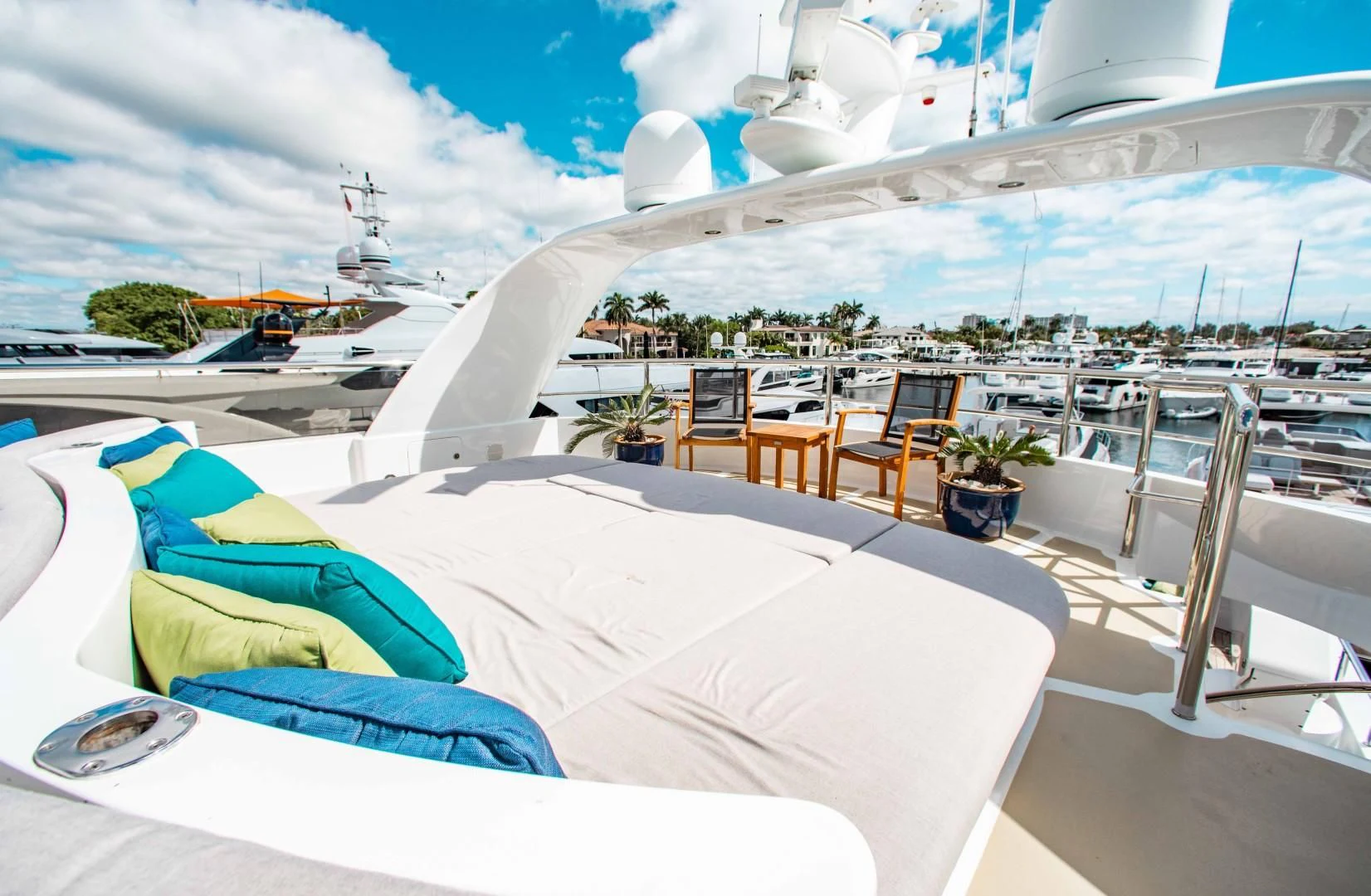 a large white tent with chairs and tables on a patio with a view of a city aboard DRIVEN Yacht for Sale