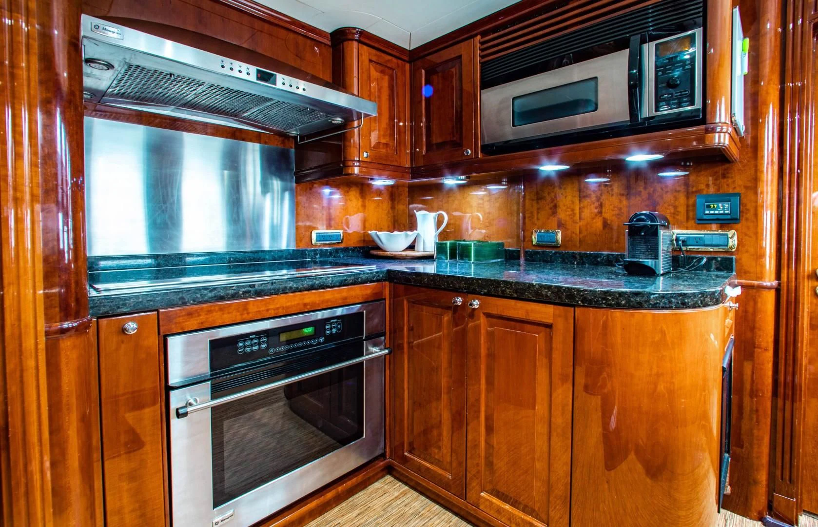 a kitchen with wooden cabinets aboard DRIVEN Yacht for Sale