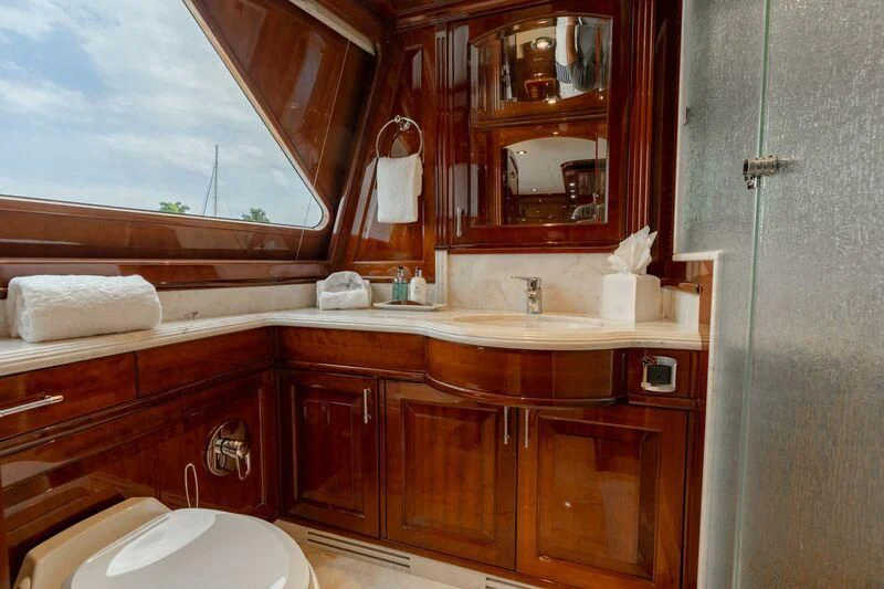 a bathroom with a sink and cabinets aboard DRIVEN Yacht for Sale