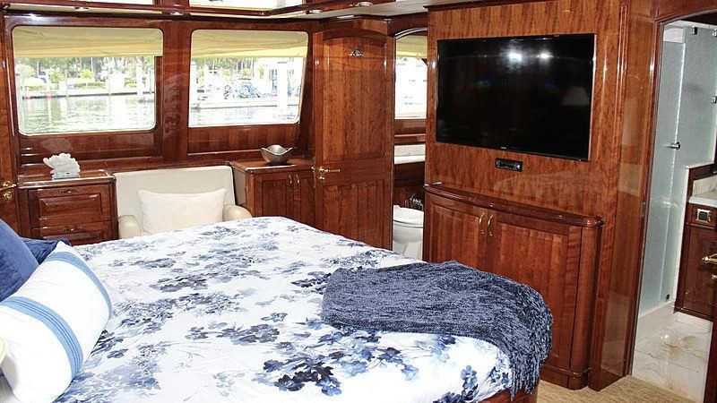 a bedroom with a large bed aboard DRIVEN Yacht for Sale