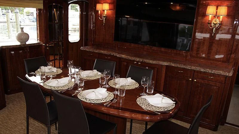 a table set with plates and glasses aboard DRIVEN Yacht for Sale