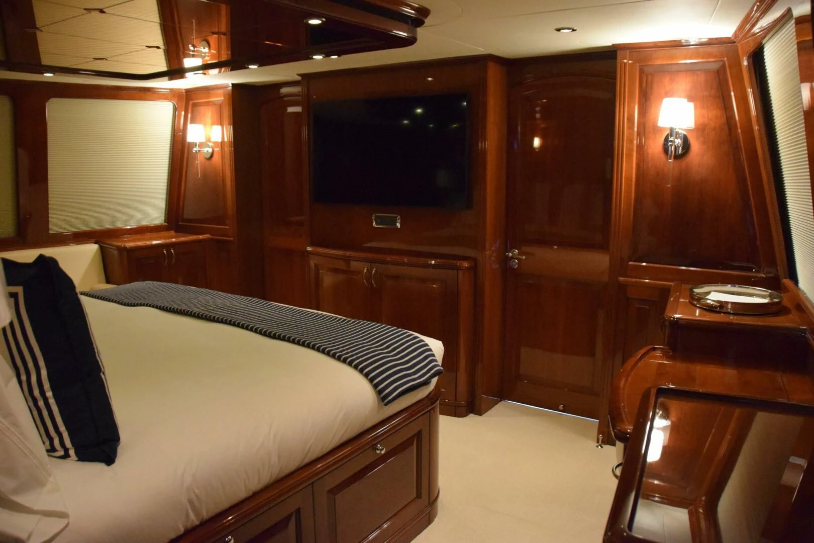 a room with a bed and a television aboard DRIVEN Yacht for Sale