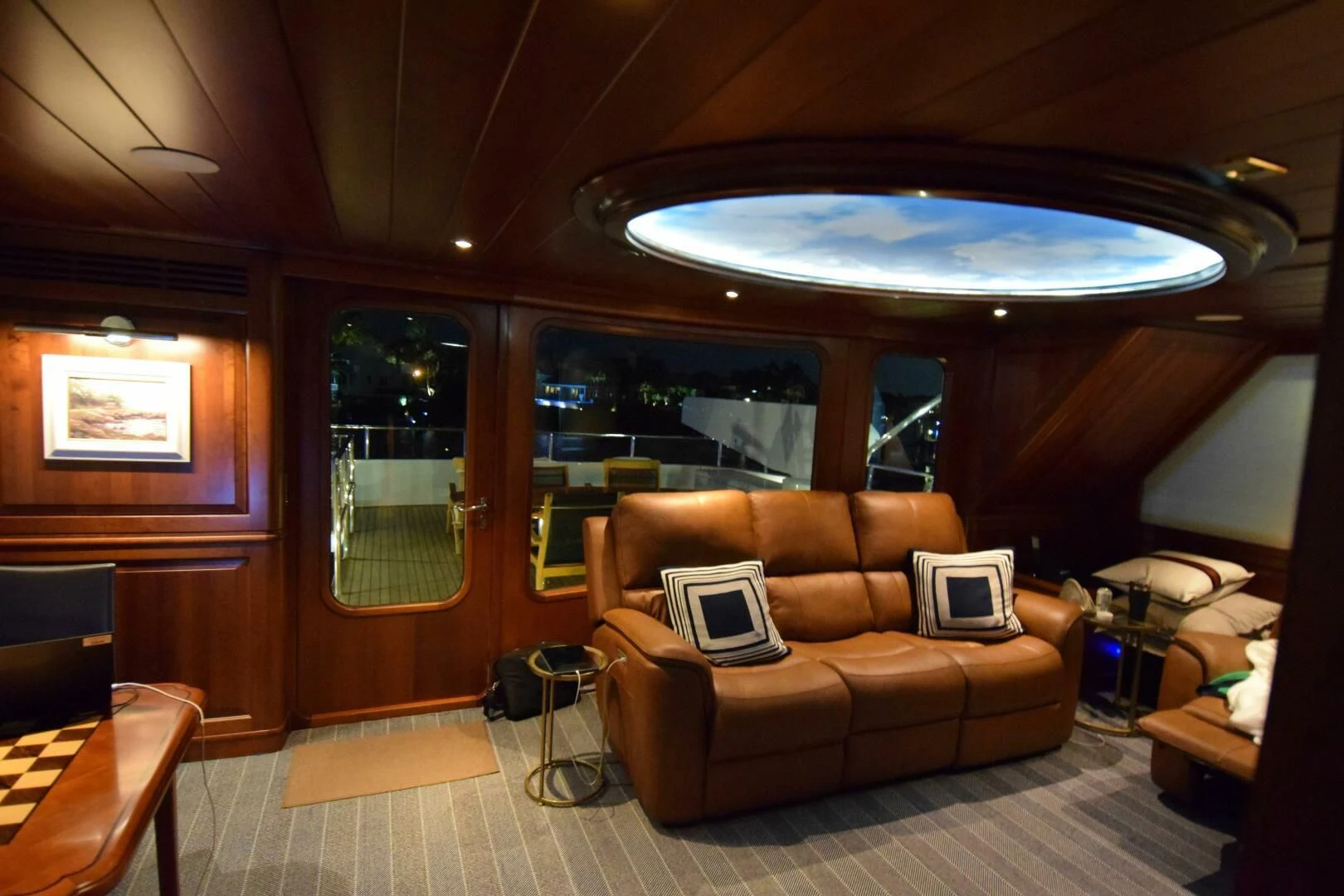a living room with a couch and a laptop aboard DRIVEN Yacht for Sale