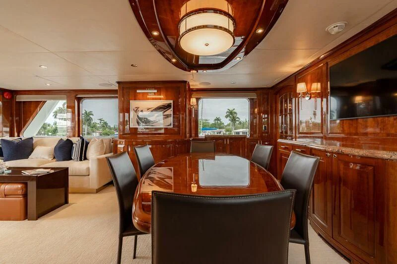 a large living room with wood cabinets aboard DRIVEN Yacht for Sale