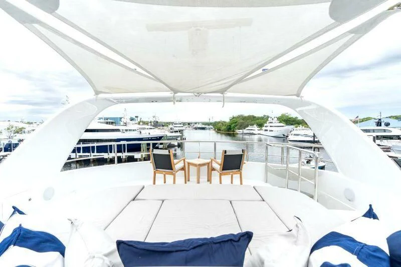 a large white tent with chairs and a table and chairs on it aboard DRIVEN Yacht for Sale