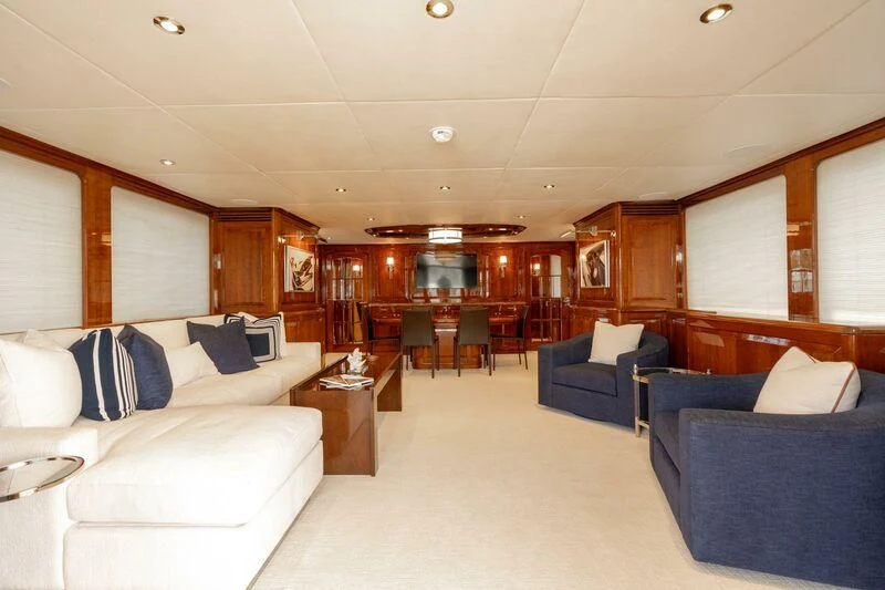 a room with couches and a table aboard DRIVEN Yacht for Sale