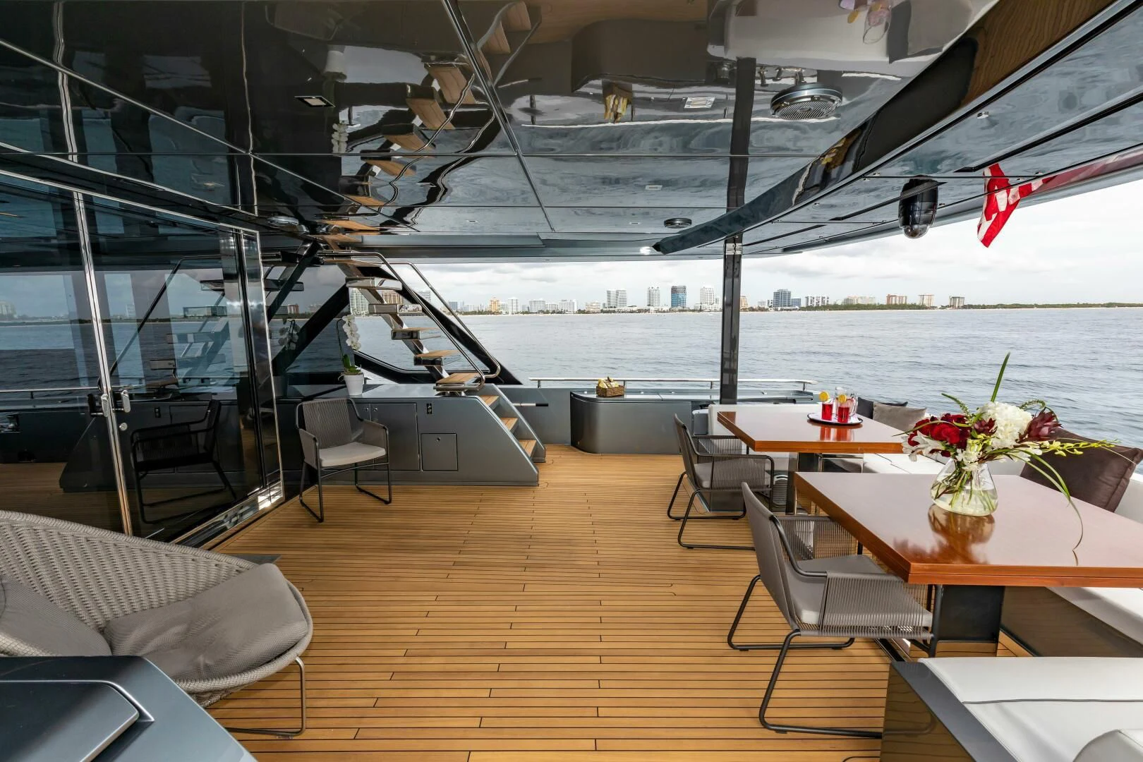 a room with a table chairs and a large body of water aboard NO SURRENDER Yacht for Sale