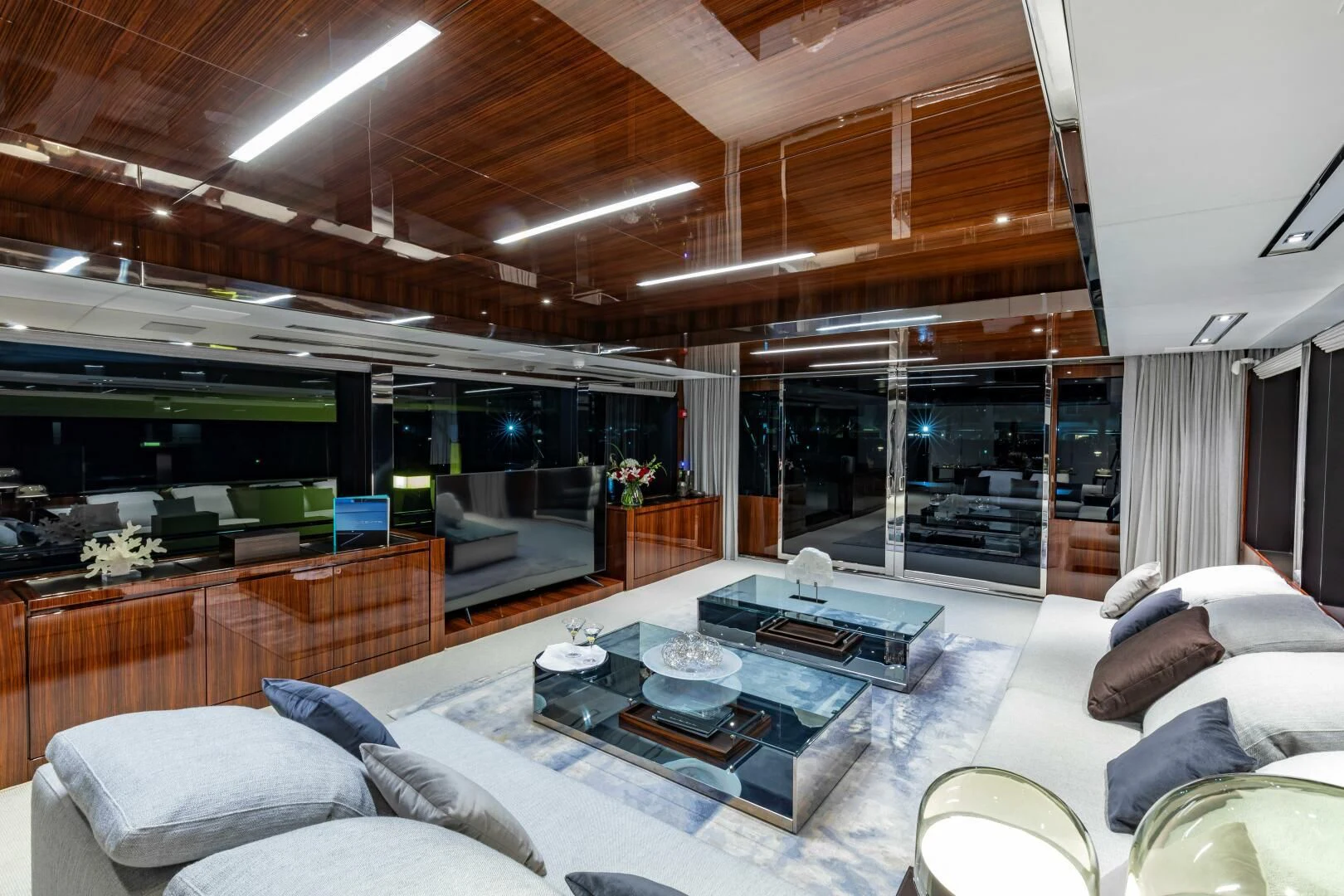 a living room with a large glass table and a large window aboard NO SURRENDER Yacht for Sale