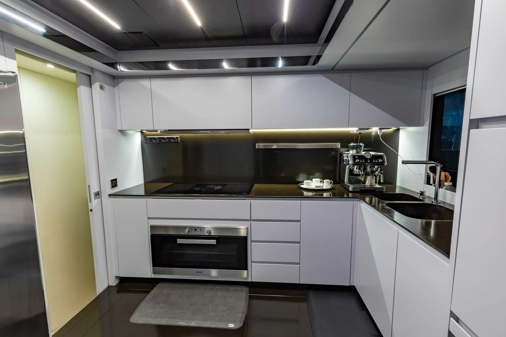 a kitchen with white cabinets aboard NO SURRENDER Yacht for Sale