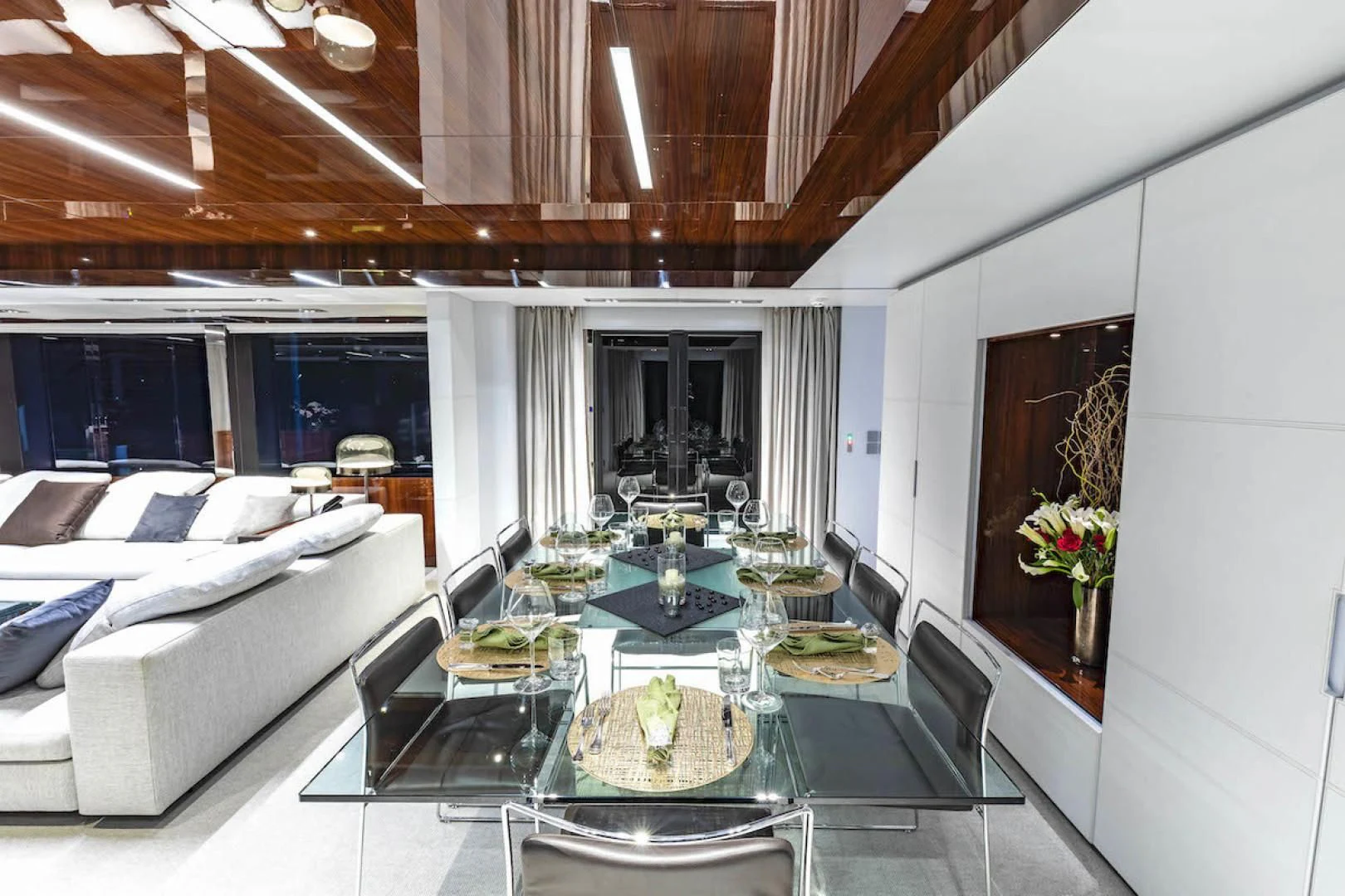 a large living room with a table and chairs aboard NO SURRENDER Yacht for Sale