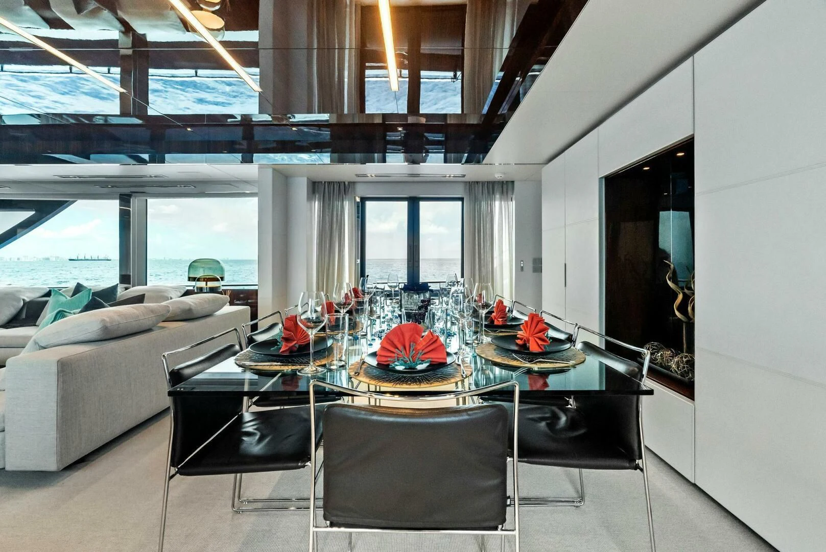 a living room with a table and chairs aboard NO SURRENDER Yacht for Sale