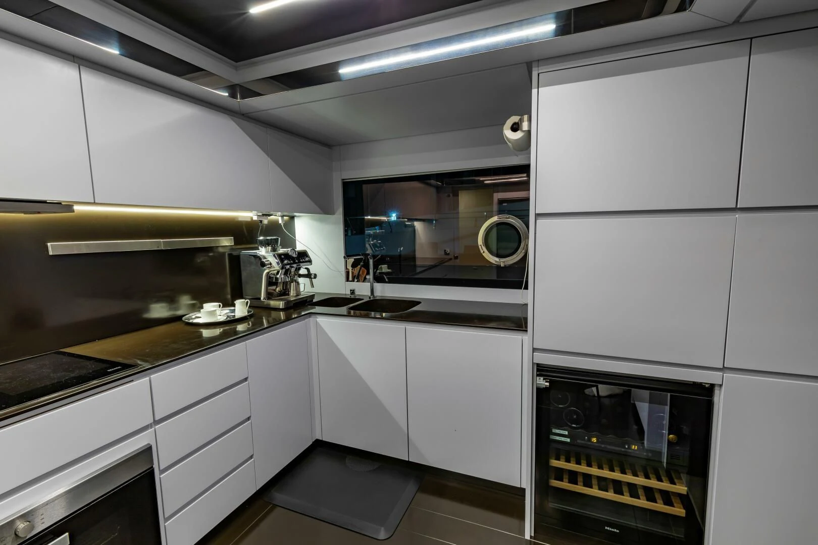 a kitchen with white cabinets aboard NO SURRENDER Yacht for Sale