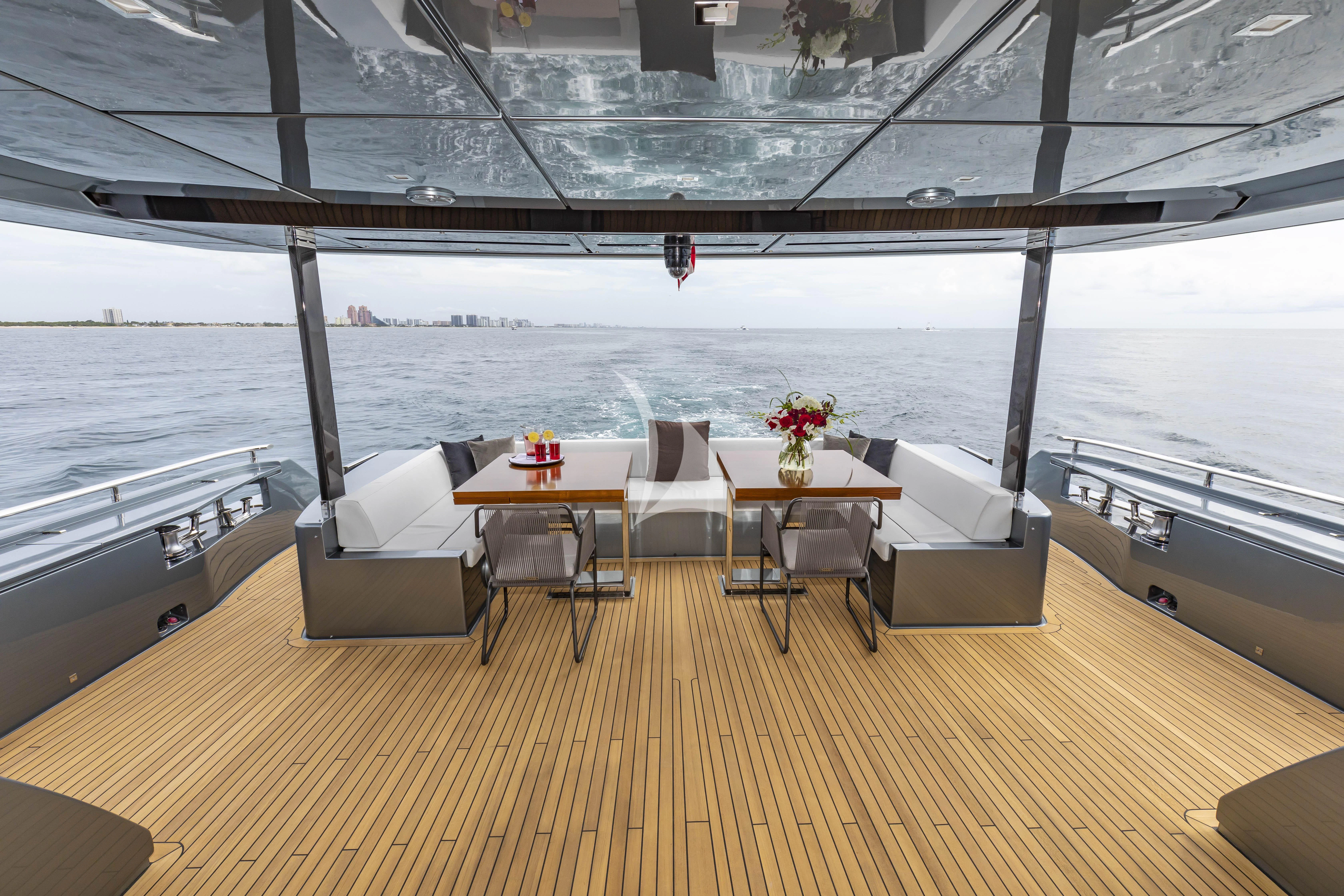a table and chairs on a deck aboard NO SURRENDER Yacht for Sale