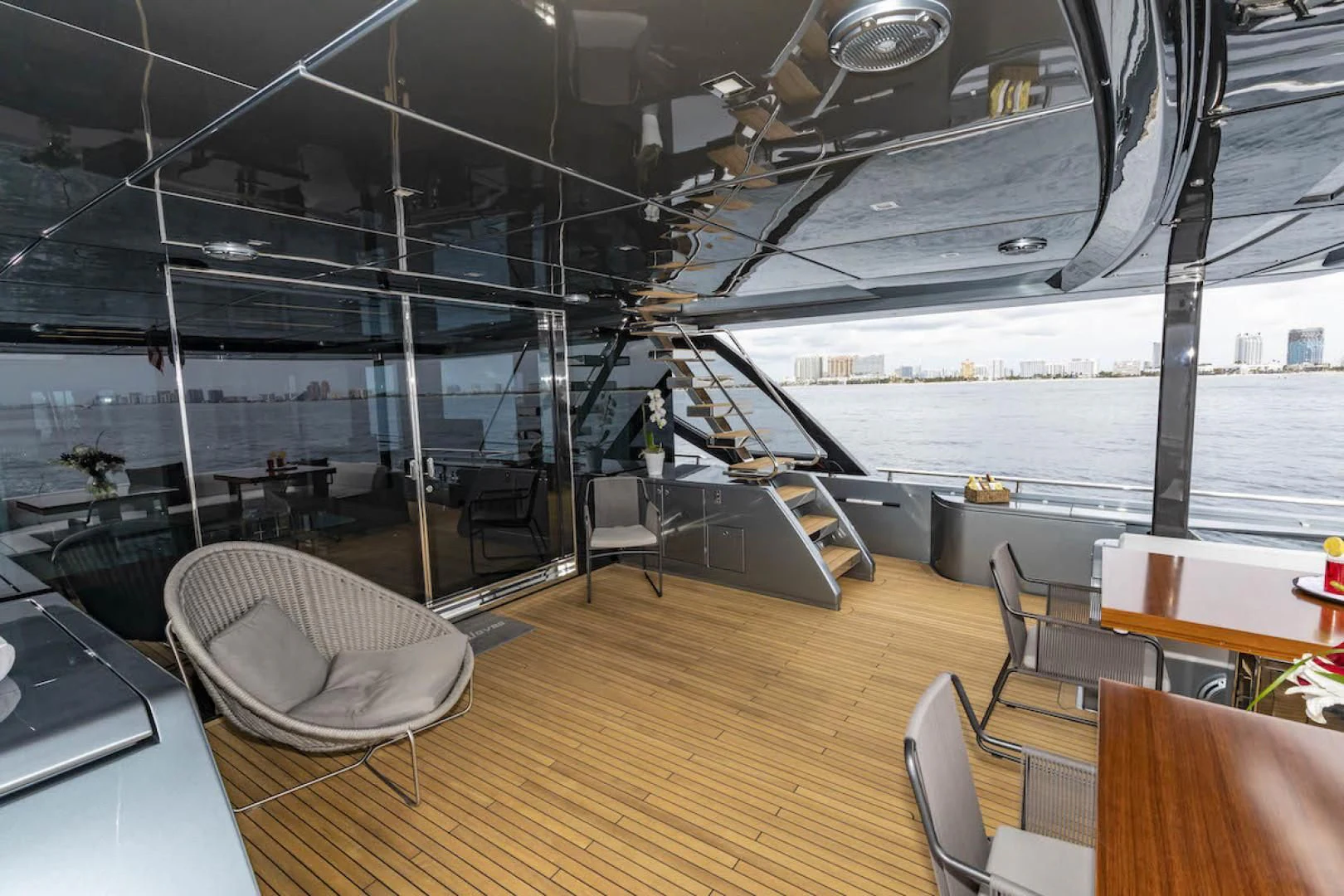 a room with a table chairs and a large window aboard NO SURRENDER Yacht for Sale