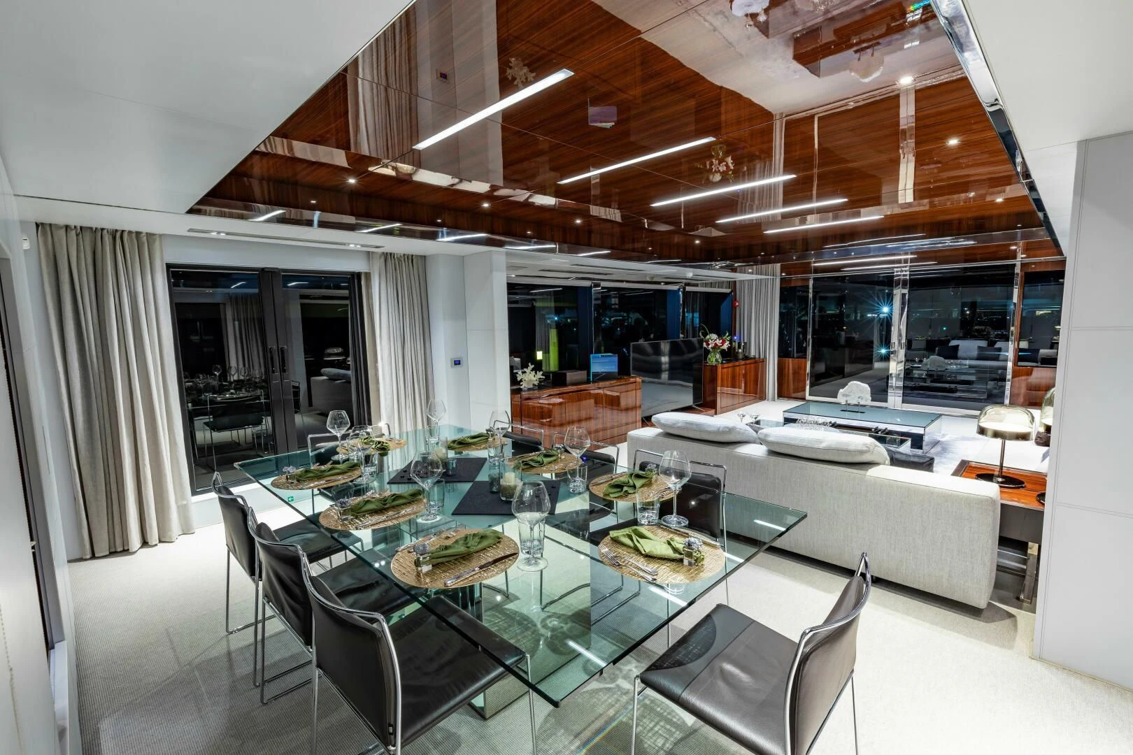 a large room with a table and chairs aboard NO SURRENDER Yacht for Sale