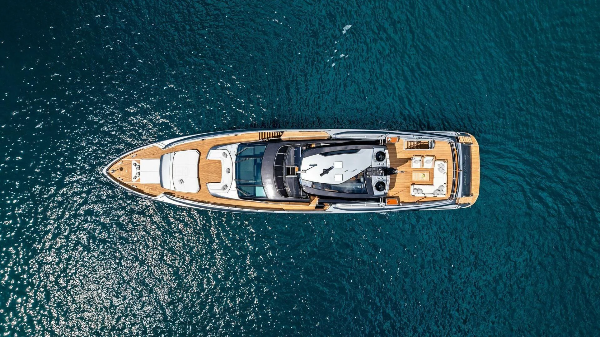 a gold and silver ship on a blue surface aboard NO SURRENDER Yacht for Sale